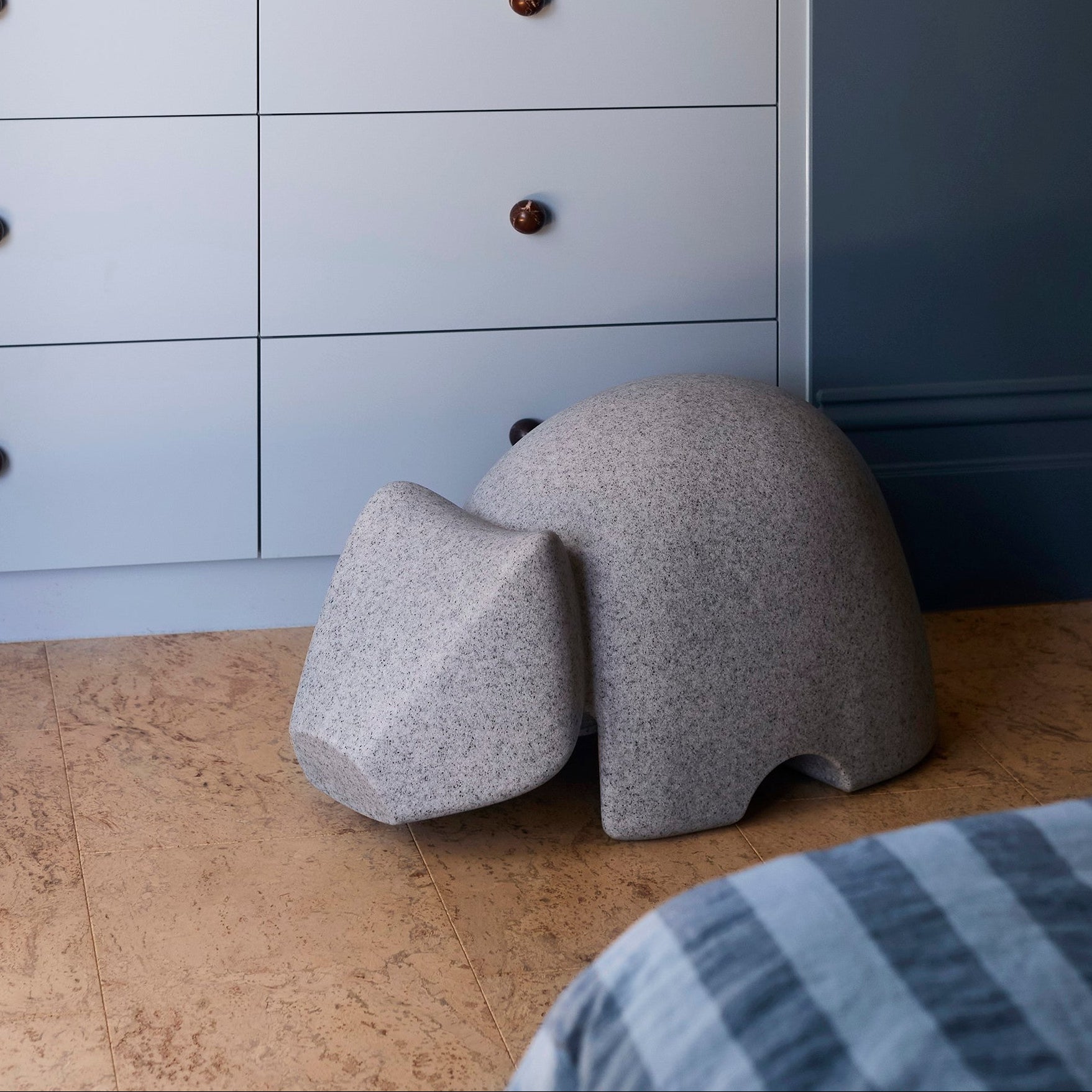 The Wisdom Wombat by Jack Flanagan on a tiled floor.